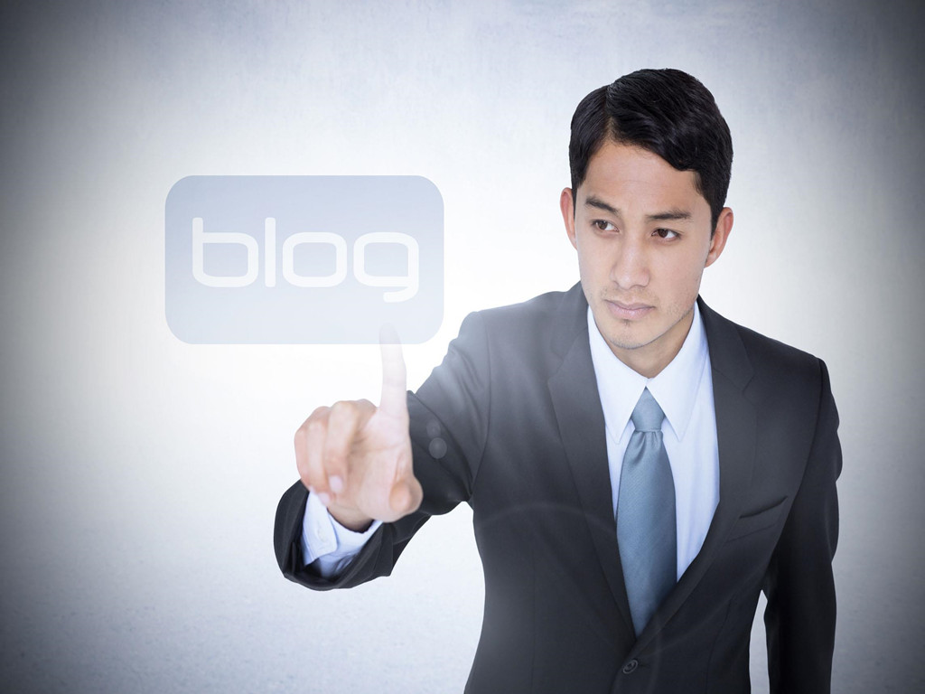The word blog and unsmiling asian businessman pointing against white wall